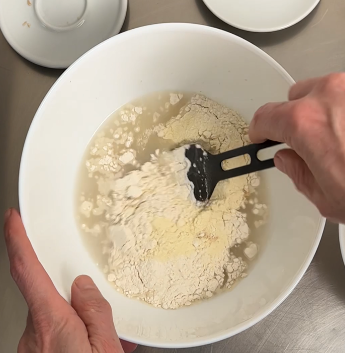 Start adding only part of the flour in water. Start with a 15% of the flour of the recipe.